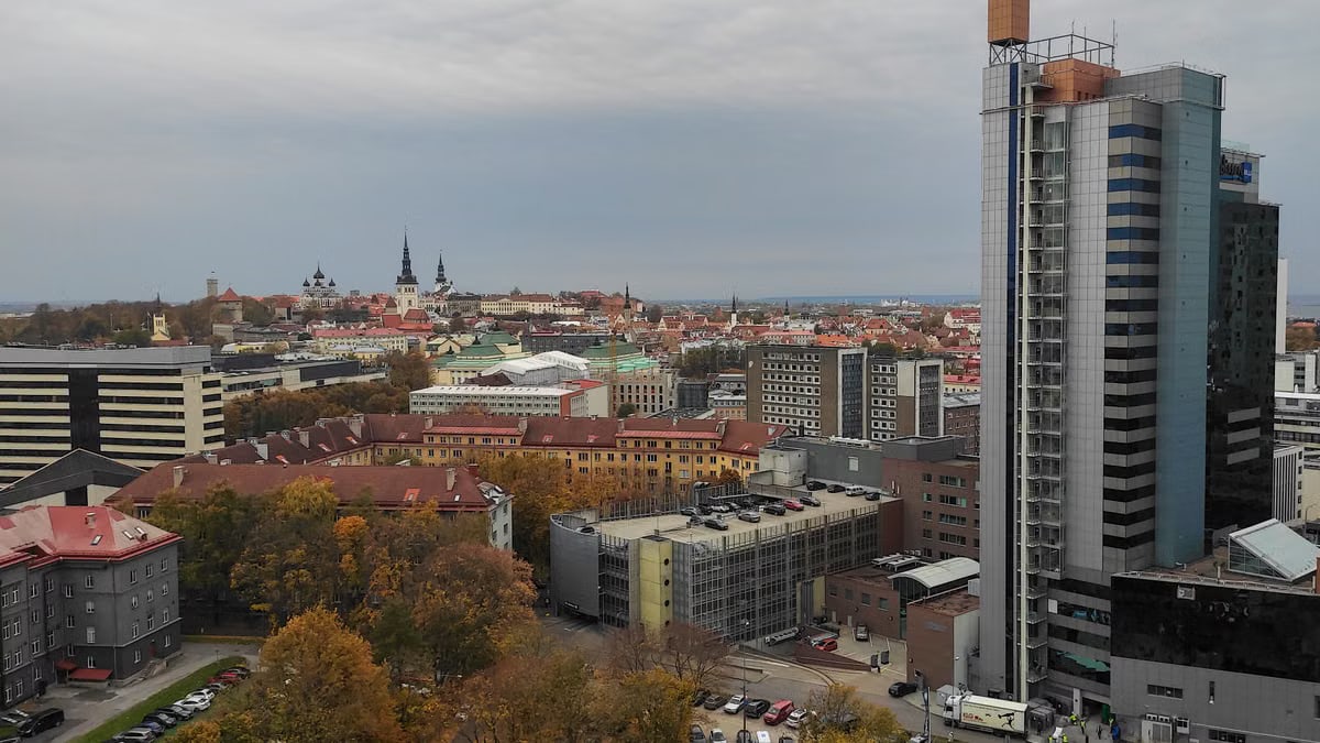 Aerial view showcasing the autumnal charm of Tallinn's historic and modern skyline.